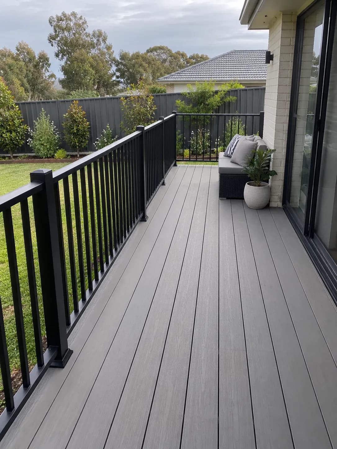 Grey composite deck boards with a black aluminium balustrade