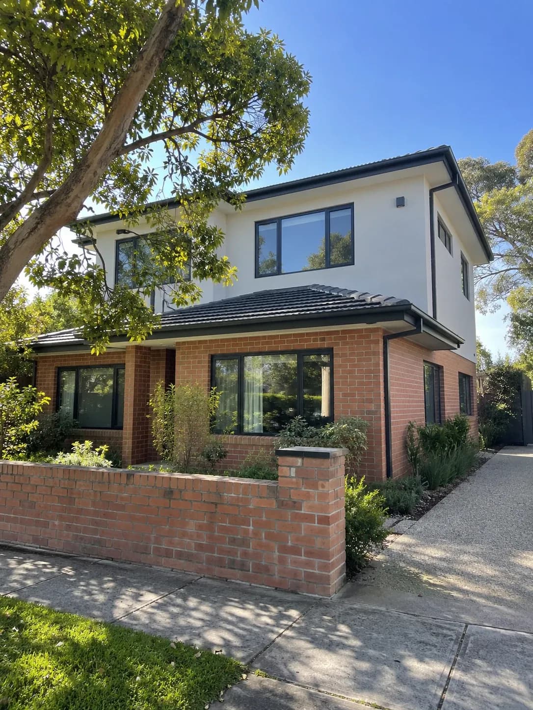 Brick home with a newly added rendered second storey