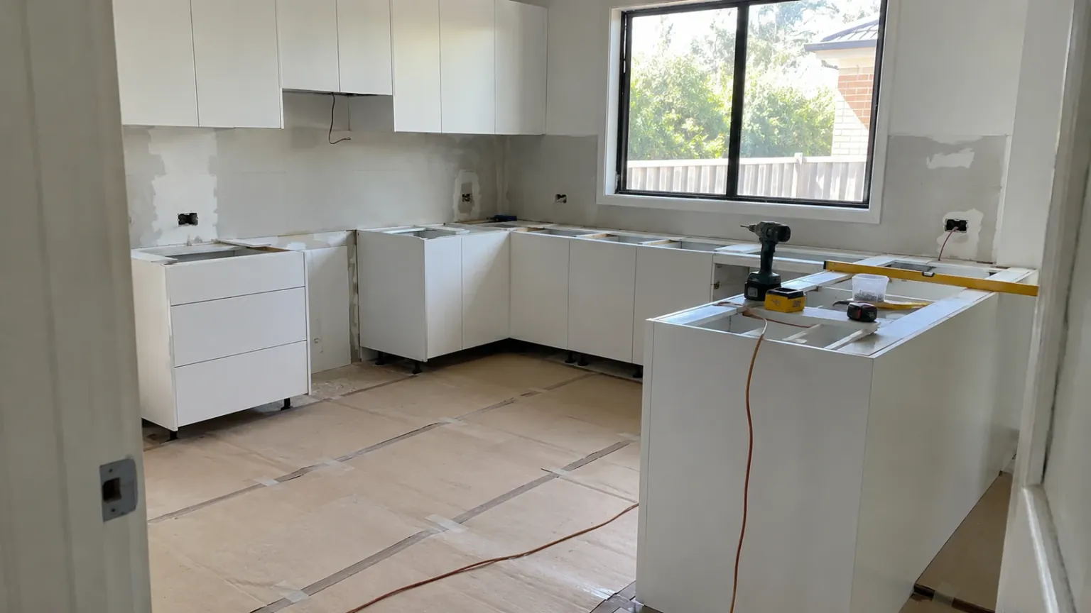 Kitchen mid-renovation with new cabinets installed and benchtops yet to be fitted