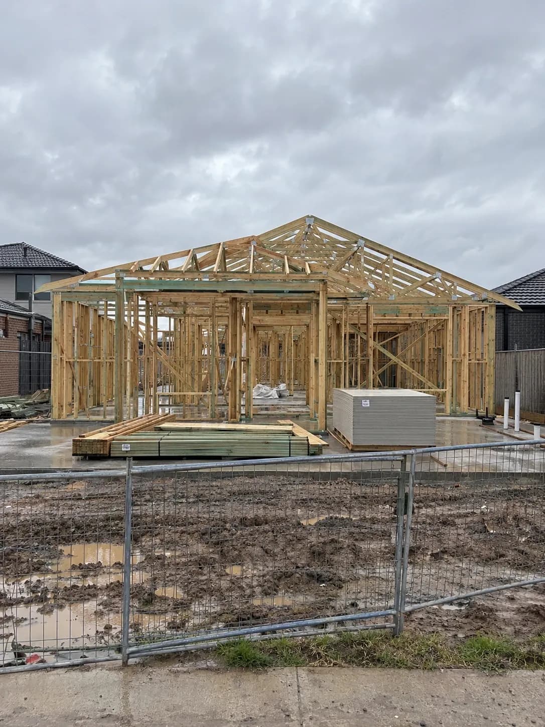 Timber wall and roof frame of a new home under construction on a concrete slab