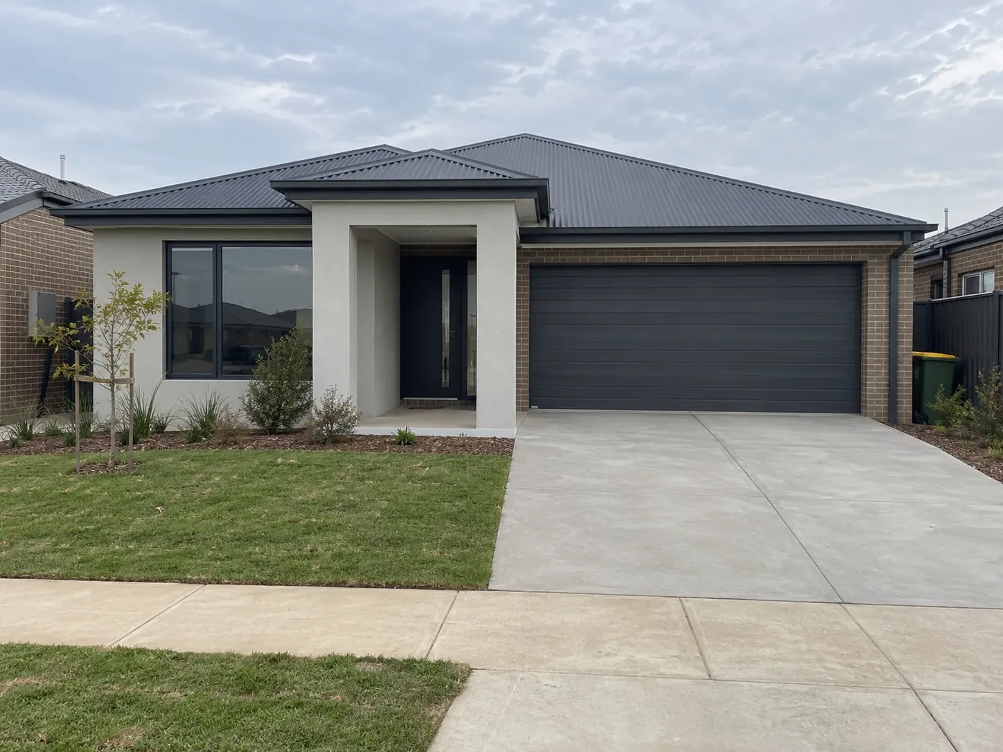 Newly built single-storey brick home with a double garage and fresh front landscaping